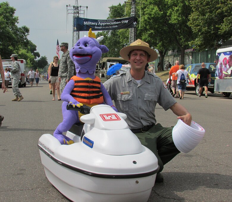 Brad Labadie, a park ranger from Eau Galle Recreation Area, near Spring Valley, Wis., escorted Seamoor the Water Safety Serpent around the fairgrounds during Military Appreciation Day at the Minnesota State Fair on August 27, 2013. Seamoor does a good job of getting everyone’s attention while Labadie talks about water safety and the importance of wearing your life jacket.