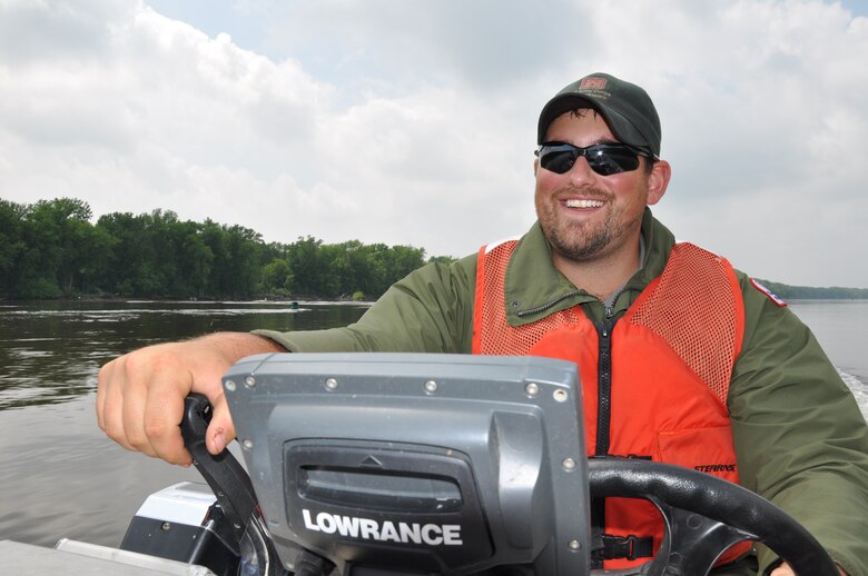 Dan Reburn, operations, drives a boat to a Mississippi River island near Red Wing, Minn., June 10.
