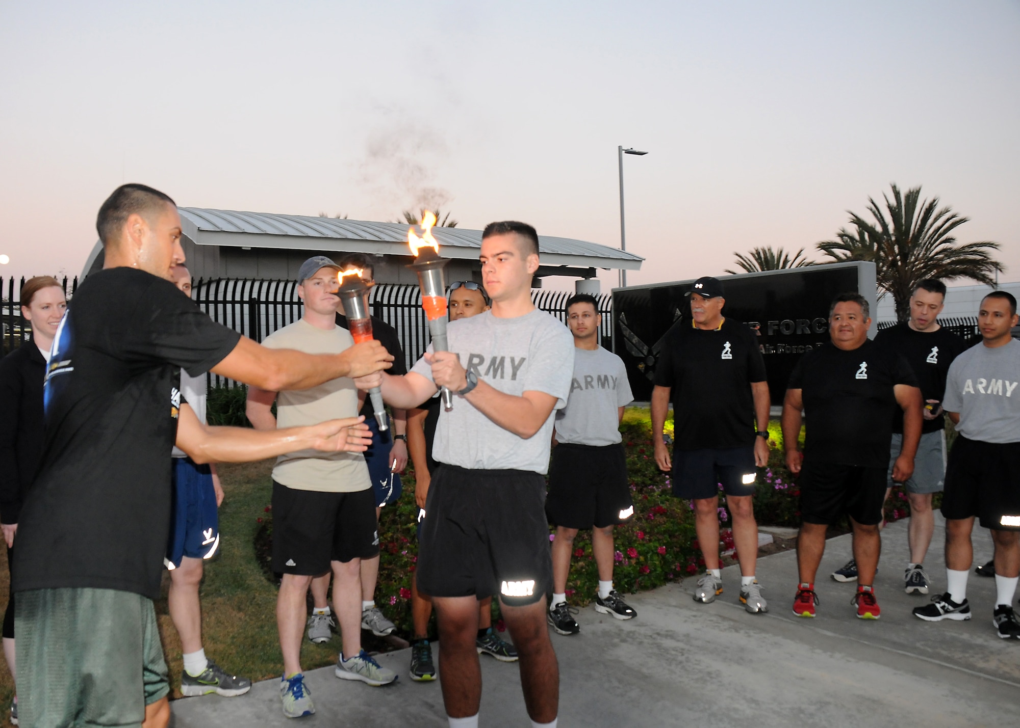 The torch is passed to the first team to run on base, Sept. 18.  (Photo by Joe Juarez)