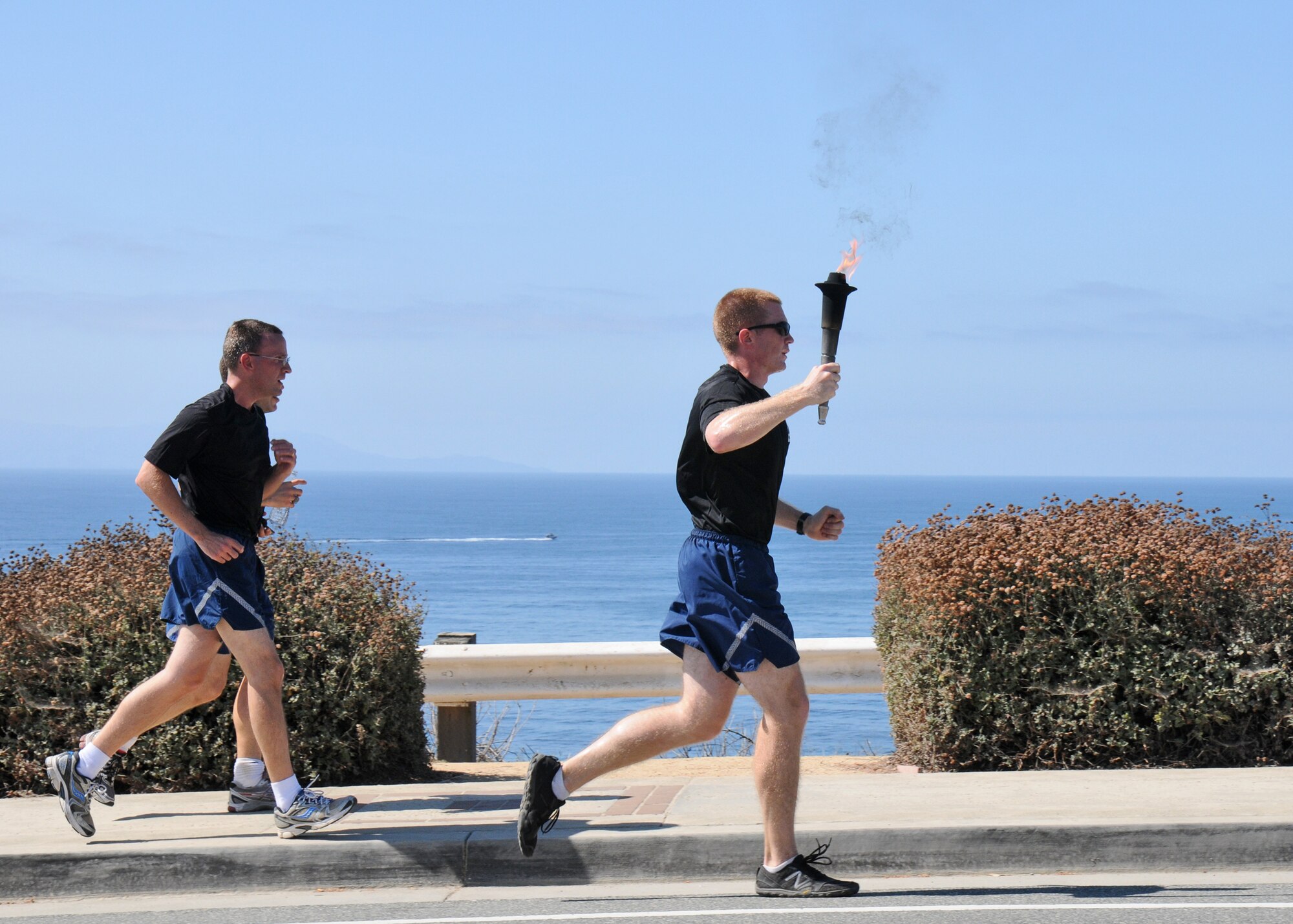 Runners run along the coast during the 24-hour POW-MIA torch relay run, Sept. 18. The event sponsored by the Los Angeles Air Force Base Company Grade Officers Council began at Terminal Island Coast Guard Base in San Pedro and concludes 54 miles later at Los Angeles AFB in El Segundo. (Photo by Joe Juarez)