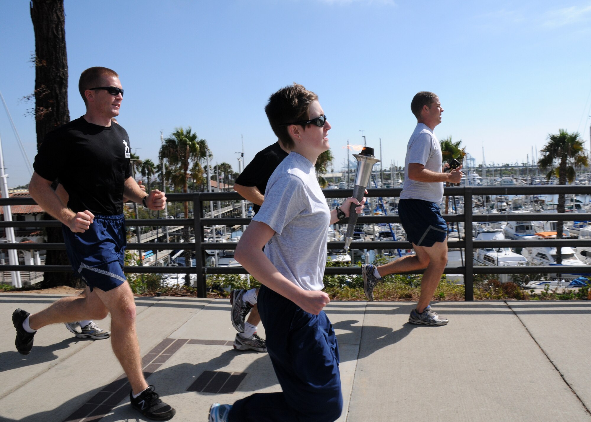 Runners pass by the Cabrillo Marina during the 24-hour POW-MIA torch relay run, Sept. 18. The event sponsored by the Los Angeles Air Force Base Company Grade Officers Council began at Terminal Island Coast Guard Base in San Pedro and concludes 54 miles later at Los Angeles AFB in El Segundo. (Photo by Joe Juarez)