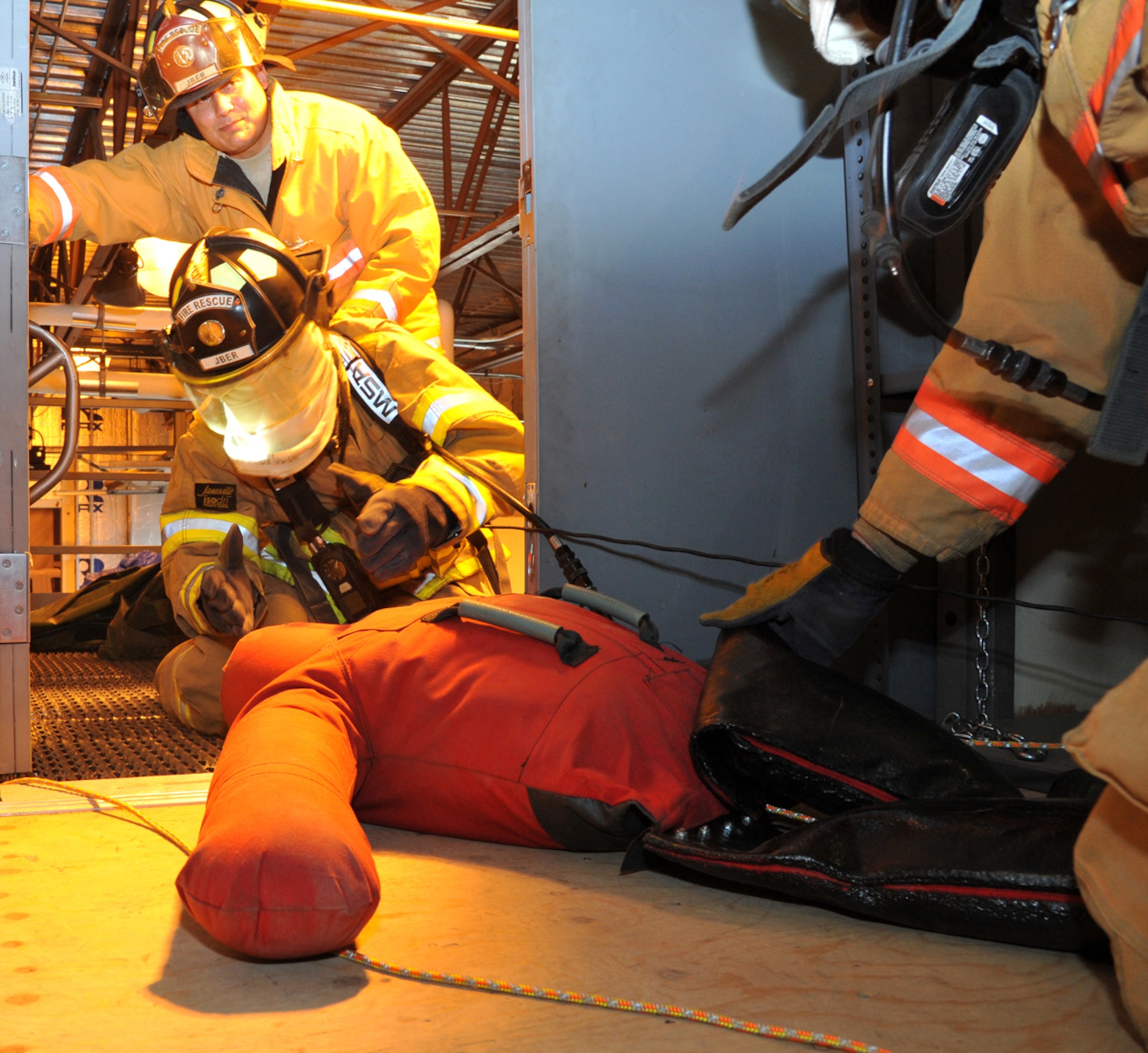 Airman 1st Class Daniel Pudlowski, 673d Civil Engineer Squadron firefighter, performs room-clearing training at Fire Station 4 on Joint Base Elmendorf-Richardson Sept. 11 as Tech. Sgt. Robert Kelly, also a 673d CES firefighter, supervises. JBER firefighters conduct daily readiness training and are expected to be able to respond to emergencies at a moment’s notice. (U.S. Air Force photo/Staff Sgt. Blake Mize)