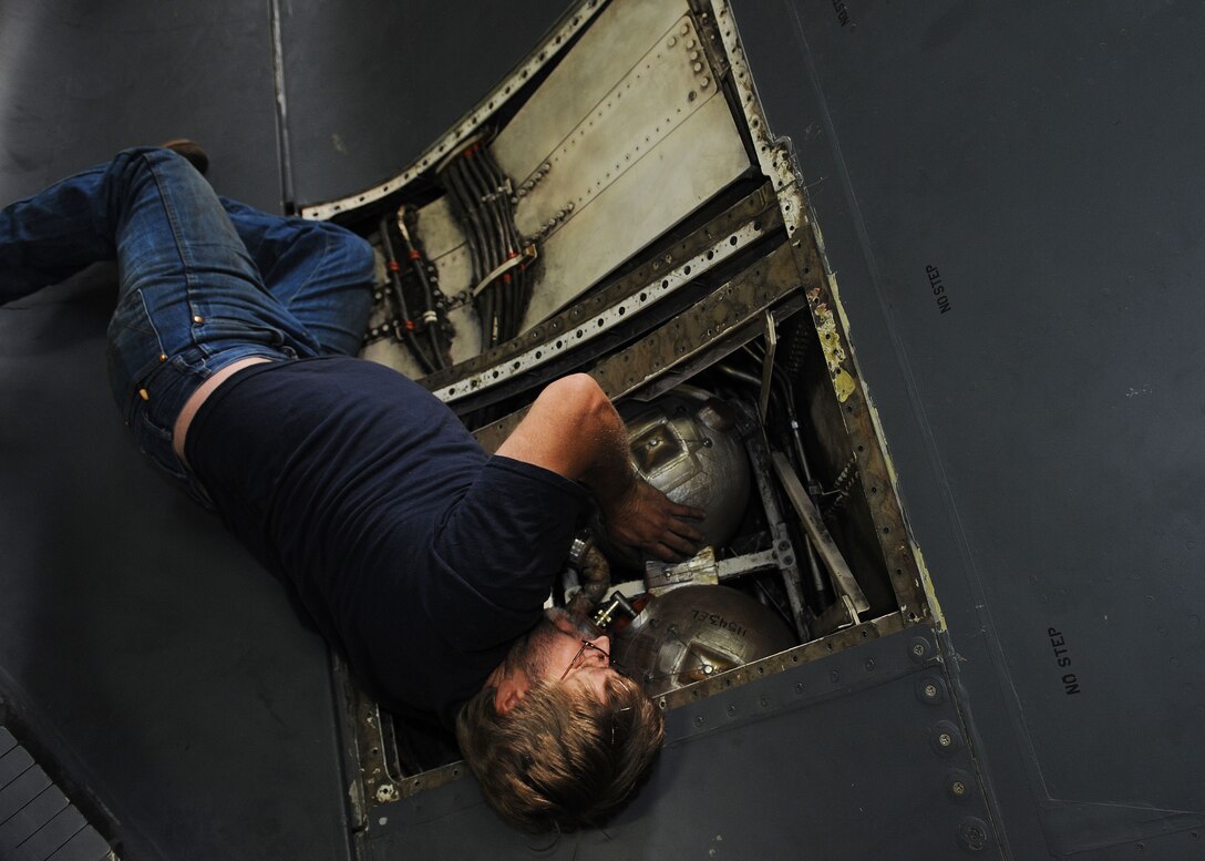 Joe Johengen, 28th Aircraft Maintenance Squadron contract field team electrical technician, replaces over wing faring fire bottles on a B-1 at Ellsworth Air Force Base, S.D., Sept. 11, 2013. The bottles provide fire suppression over the wings of the aircraft in the case of an accident or incident. (U.S. Air Force photo by Airman 1st Class Rebecca Imwalle/Released)