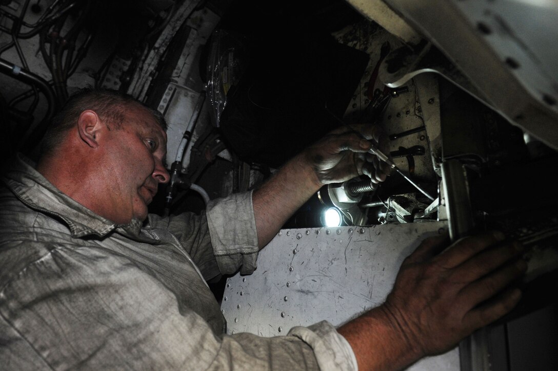 Kelly Kowaleski, 28th Aircraft Maintenance Squadron contract field team hydraulics specialist, replaces a wing bearing on a B-1 at Ellsworth Air Force Base, S.D., Sept. 11, 2013. The bearings which allow for a smooth transition as the wings are swept back and forth are replaced every 150 days during home station maintenance checks. (U.S. Air Force photo by Airman 1st Class Rebecca Imwalle/Released)