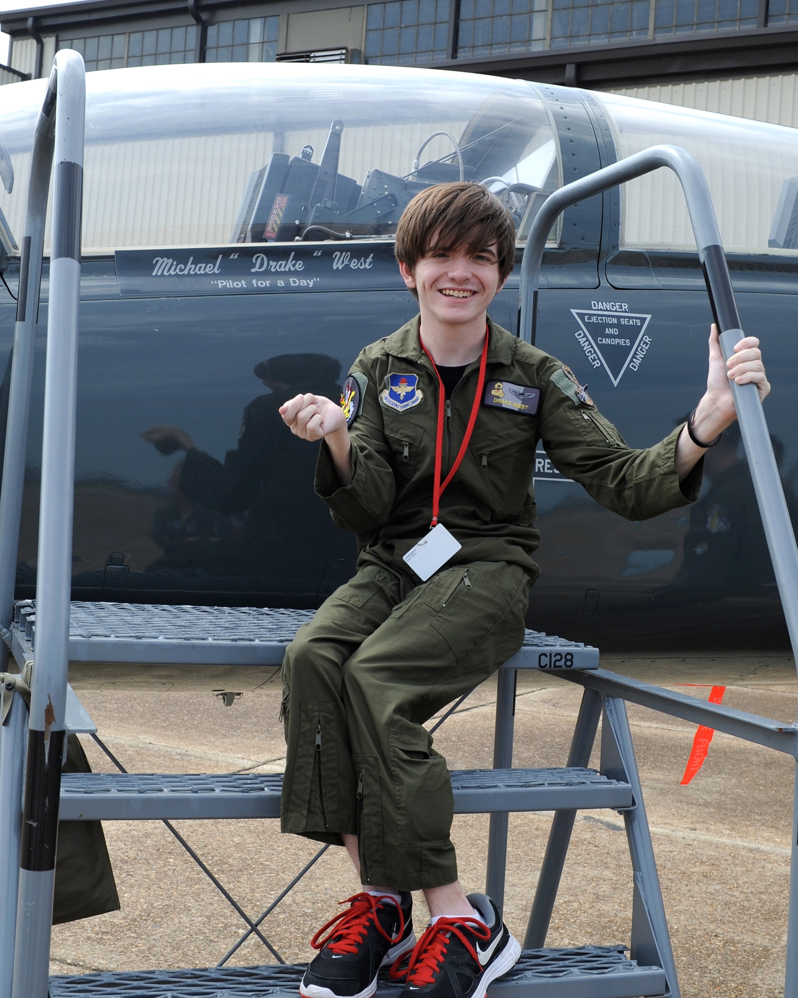Drake West, Pilot for a Day participant, poses next to his name on a T-38C Talon on Sept. 13 at Columbus Air Force Base, Miss. West, who suffers from cerebral palsy, spent the day experiencing life as a pilot and touring various Columbus Air Force Base facilities. (U.S. Air Force Photo/Elizabeth Owens)