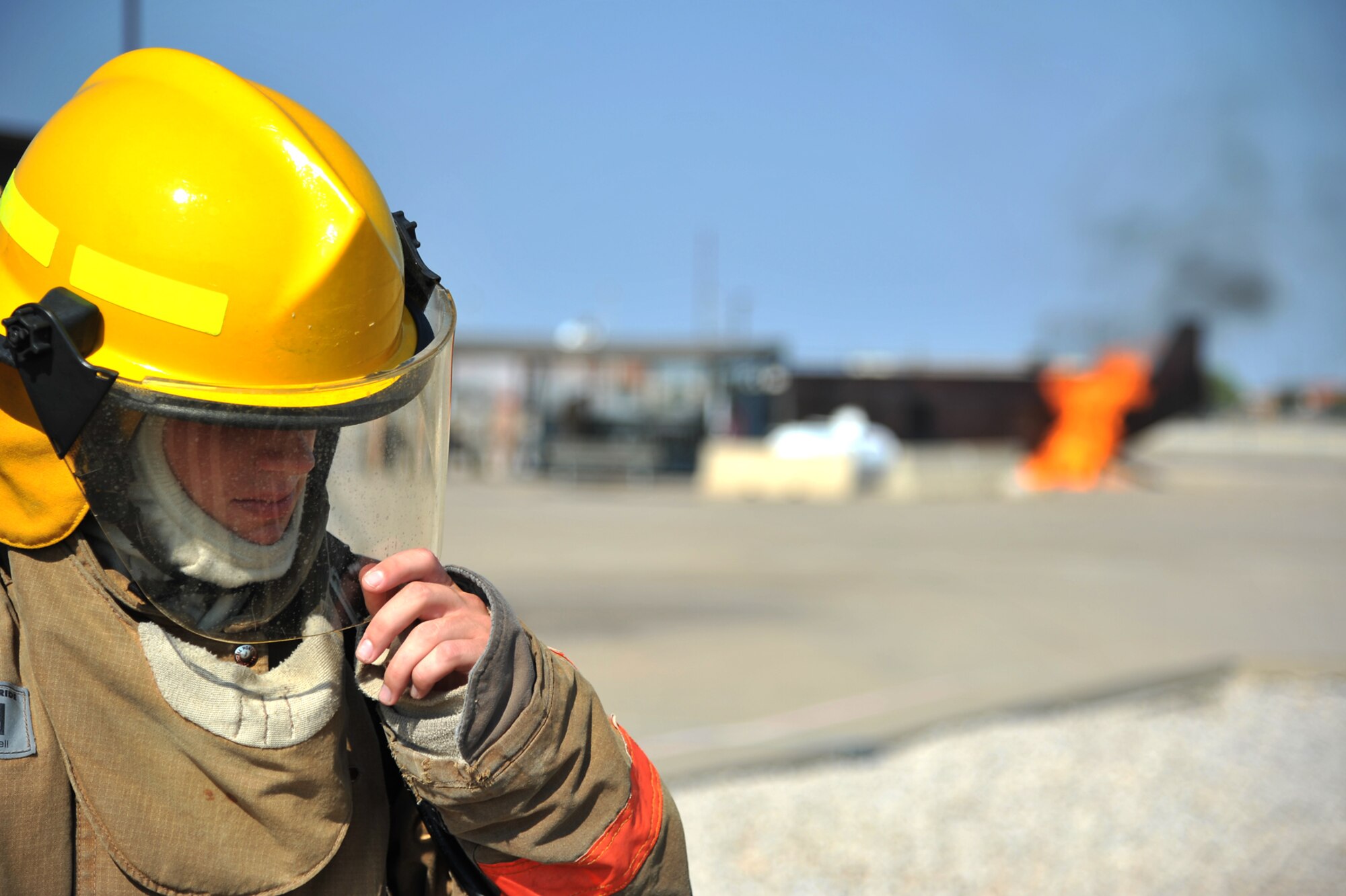 GOODFELLOW AIR FORCE BASE, Texas - Airman 1st Class Britt Beshear, 312th Training Squadron student, adjusts his helmet at the Louis F. Garland Department of Defense Fire Academy Sept. 6. The Academy services all aspects of the DoD; including Army, Marine Corps, Navy, Air Force, and Civil Service employees. (U.S. Air Force/ Senior Airman Michael Smith)