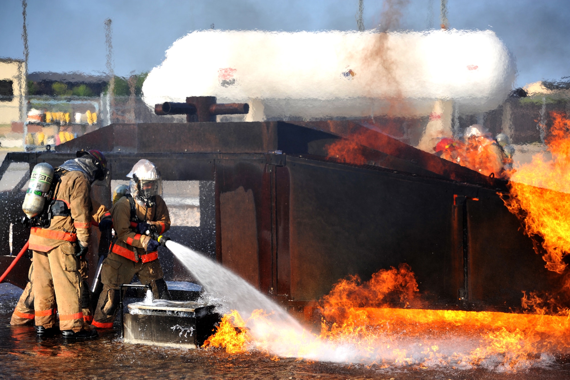 GOODFELLOW AIR FORCE BASE, Texas - Students from the 312th Training Squadron put out a fire in the Helo Trainer at the Louis F. Garland Department of Defense Fire Academy Sept. 6. The Academy services all aspects of the DoD; including Army, Marine Corps, Navy, Air Force, and Civil Service employees. (U.S. Air Force/ Senior Airman Michael Smith)