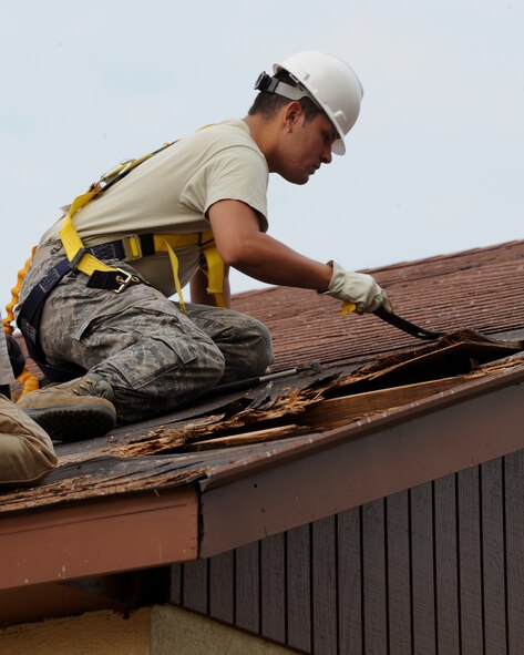 Senior Airman Pashala Lewis, 2nd Civil Engineer Squadron structures section, removes a roof decking from a building on Barksdale Air Force Base, La., Sept. 18, 2013. Repairing the roof will prevent leaks and protect equipment stored inside. (U.S. Air Force photo/Senior Airman Benjamin Gonsier)