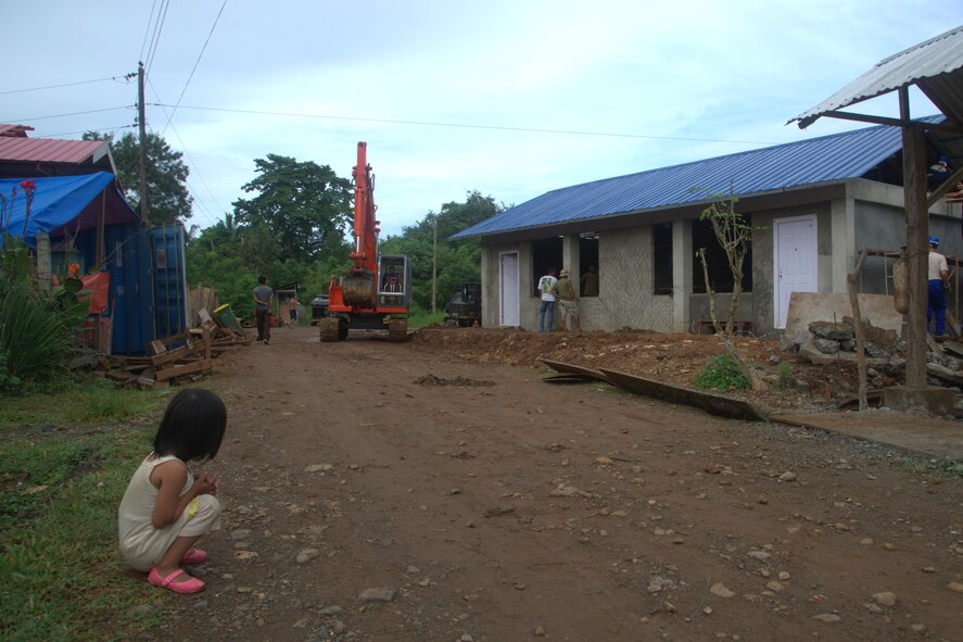 A child watches Pacific Unity 2013-7 construction efforts Sept. 13, 2013, at the Virgilio
R. Magbanua Memorial Elementary School, Puerto Princesa, Philippines. Airmen from the 18th Civil Engineer Group from Kadena Air Base, Japan, U.S. Navy and Philippine Air Force counterparts, are building two new classrooms for the school. Pacific Unity is a bilateral Engineering Civic Action Program (ENCAP) conducted in the Asia-Pacific region in collaboration with host nation civil authorities and military
personnel. (U.S. Air Force photo/Master Sgt. Ryan Kruse)
