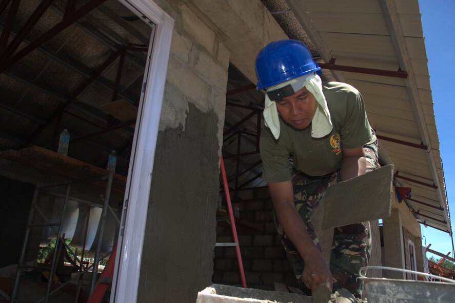 An Airman from the Philippine Air Force gets more mortar for plastering Sept. 10, 2013, at the Virgilio R. Magbanua Memorial Elementary School, Puerto Princesa, Philippines. He's working with Airmen from the 18th Civil Engineer Group from Kadena Air Base, Japan as well as U.S. Navy as part of Pacific Unity 2013-7. Pacific Unity is a bilateral Engineering Civic Action Program (ENCAP) conducted in the Asia-Pacific region in collaboration with host nation civil authorities and military personnel. (U.S. Air Force photo/Master Sgt. Ryan Kruse)
