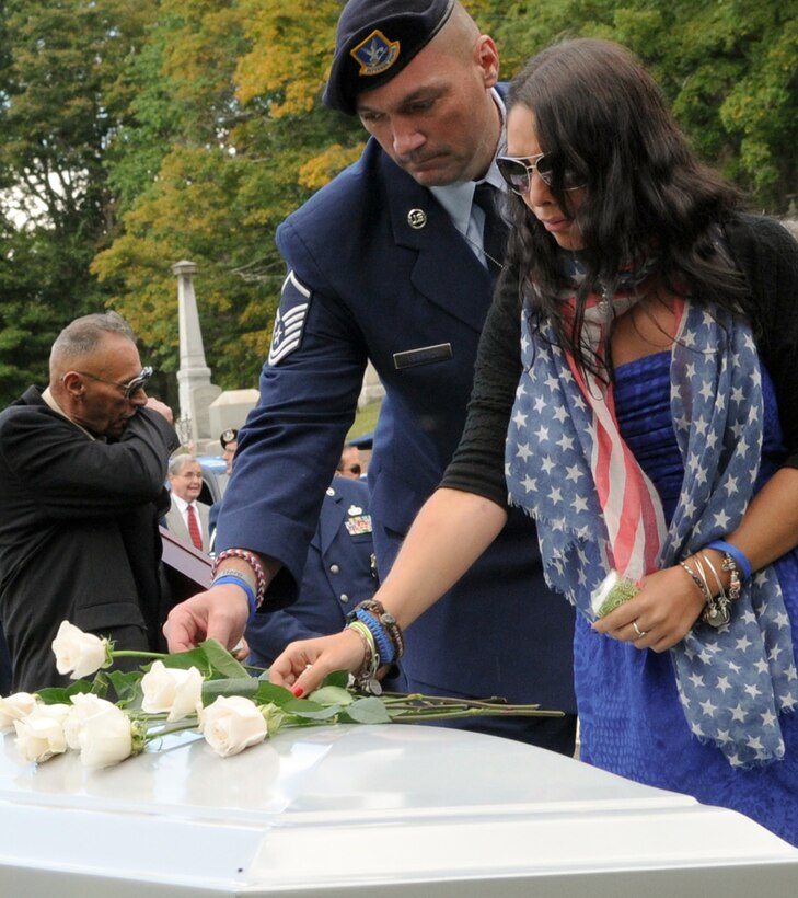 SHERMAN, CT—New York Air National Guard Master Sgt. Todd Lobraico Sr. places a white rose on the coffin of his son, Staff Sgt Todd “TJ” Lobraico Jr. who was killed in action in Afghanistan during burial services at North Cemetery here on Friday, Sept. 13. He is accompanied by Jessica Germano, his son’s girlfriend. Staff Sgt. Lobraico belonged to the 105th Security Forces Squadron of the New York Air National Guard’s 105th Airlift Wing. U.S. Air National Guard Photo by Tech Sgt. Michael O'Halloran)