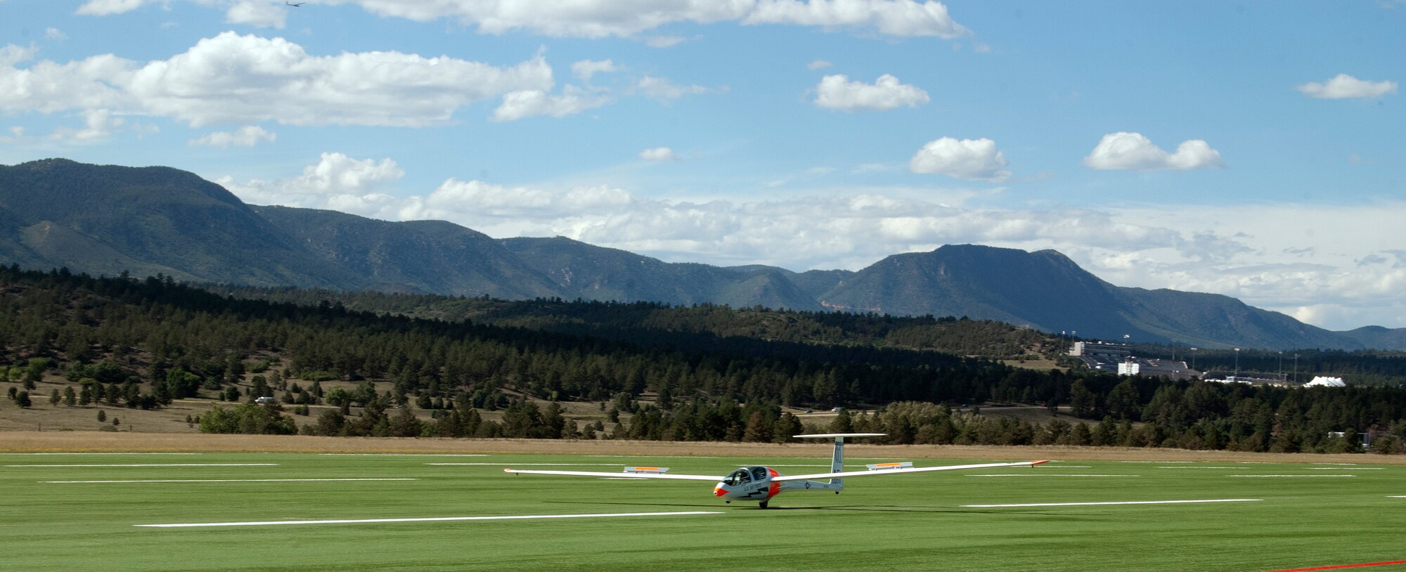 Cadet 3rd Class Adam Marcinkowski brings his TG-16A glider in for a picture-perfect landing on his first solo flight at the Air Force Academy Airfield Sept. 17, 2013. A second glider on approach (top left)  illustrates the operations tempo at the Academy, which has one of the busiest visual flight rules-only airfields in the United States. (U.S. Air Force photo/Don Branum)