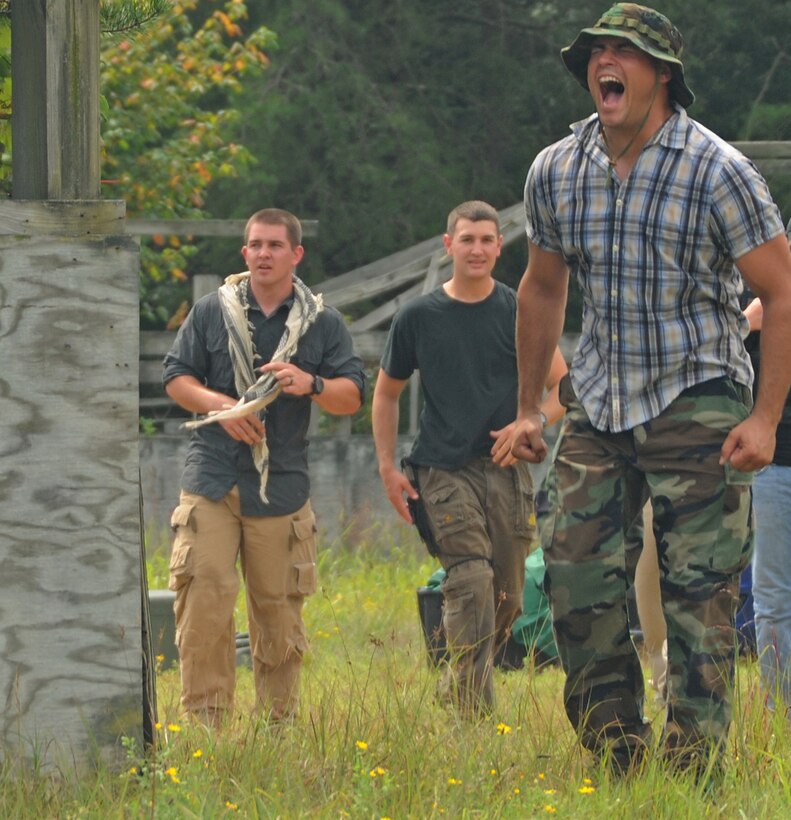 Staff Sgt. Jesse McCarley screams to intimidate pilots from Joint Base Andrews during a combat training exercise at Davidsonville Communications Site, Md., Aug. 21, 2013. The daylong exercise was designed to teach survival skills in the event of an aircraft mishap.  McCarley is the aircrew continuation training noncommissioned officer in charge with the 113th Operations Support Flight. (U.S. Air Force photo/Airman 1st Class Erin O’Shea)