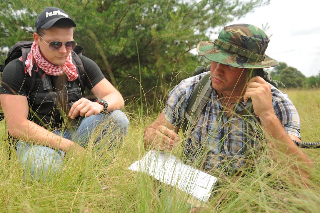 Senior Airman Yuriy Dubrov, left, and Staff Sgt. Jesse McCarley, set up a radio communication site during a combat survival training exercise at Davidsonville Communications Site, Md., Aug. 21, 2013. The daylong exercise was designed to teach survival skills in the event of an aircraft mishap. Dubrov is a radio frequency technician with the 89th Communications Squadron.  McCarley is the aircrew continuation training noncommissioned officer in charge with the 113th Operations Support Flight. (U.S. Air Force photo/Airman 1st Class Erin O’Shea)