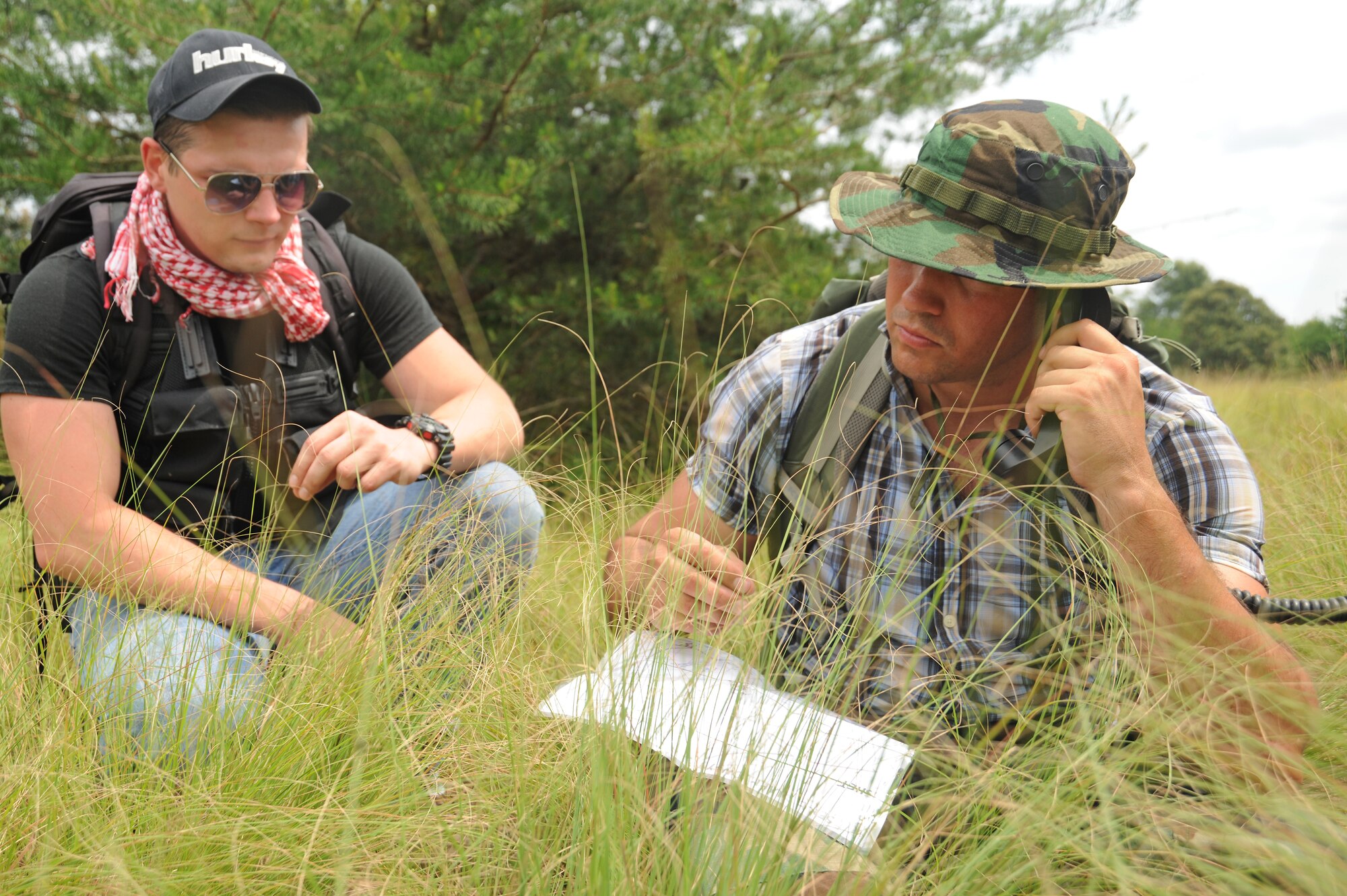 Senior Airman Yuriy Dubrov, left, and Staff Sgt. Jesse McCarley, set up a radio communication site during a combat survival training exercise at Davidsonville Communications Site, Md., Aug. 21, 2013. The daylong exercise was designed to teach survival skills in the event of an aircraft mishap. Dubrov is a radio frequency technician with the 89th Communications Squadron.  McCarley is the aircrew continuation training noncommissioned officer in charge with the 113th Operations Support Flight. (U.S. Air Force photo/Airman 1st Class Erin O’Shea)
