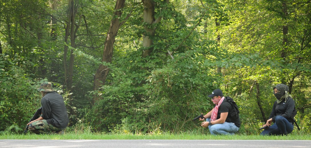 Airmen from Joint Base Andrews prepare to hijack a vehicle during a training exercise at Davidsonville Communications Site, Md., Aug. 21, 2013. The exercise was designed to teach survival techniques in the event of an aircraft mishap or aircrew capture. Pilots assigned to Joint Base Andrews participated in the daylong exercise. (U.S. Air Force photo/Airman 1st Class Erin O’Shea)