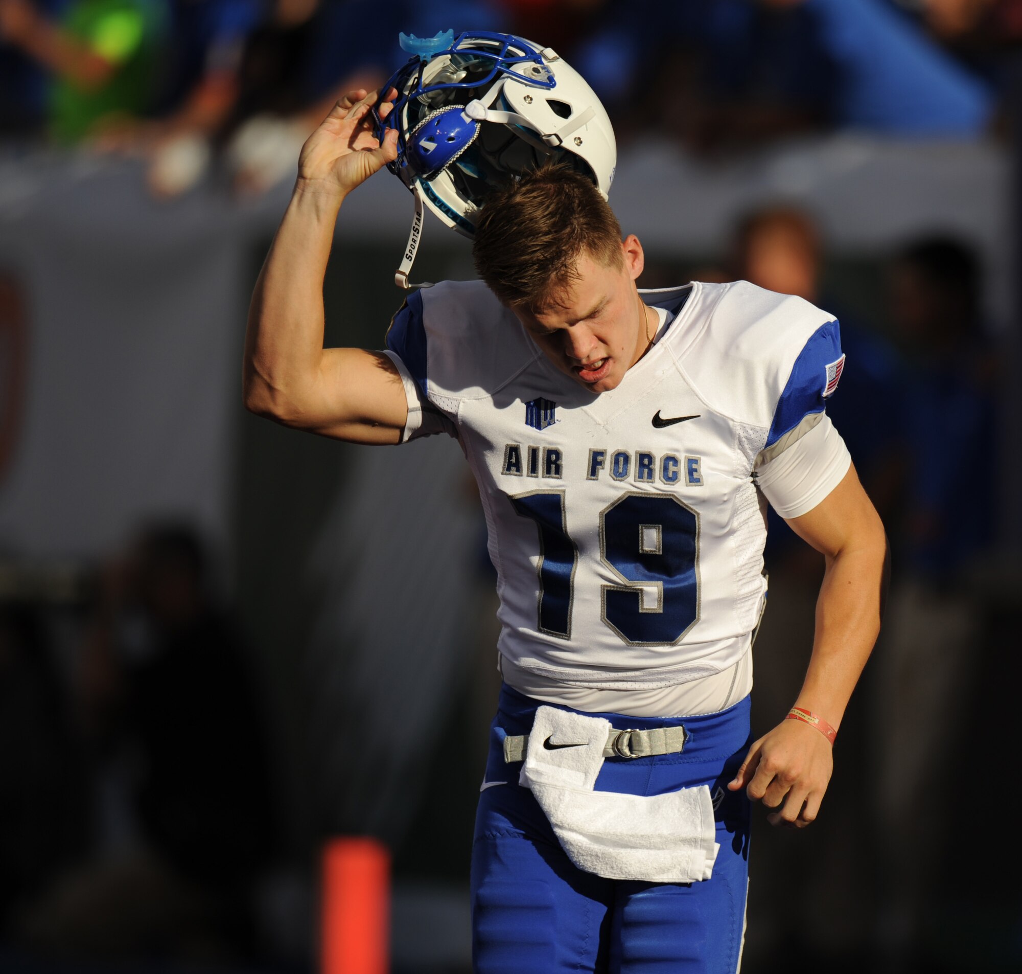 Air Force Academy football player David Baska takes off his helmet during the AFA versus Boise State University football game Sept. 13, 2013, at Bronco Stadium in Boise, Idaho. More than 36,000 fans were in attendance to view the Mountain West conference matchup. (U.S. Air Force photo by Senior Airman Benjamin Sutton/Released) 