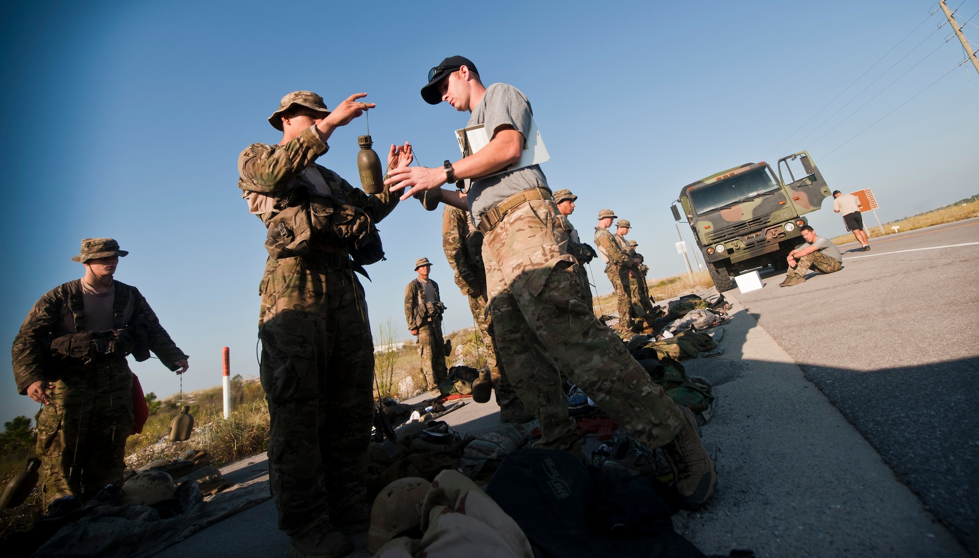 A Special Tactics instructor, right, checks a canteen after a 12-mile ruck march in Fort Walton Beach, Fla., Sept. 13, 2013. The Special Tactics candidates had four hours to complete the ruck march, which is one of the final tests they must pass before graduating technical school. (U.S. Air Force photo/Senior Airman Krystal M. Garrett)