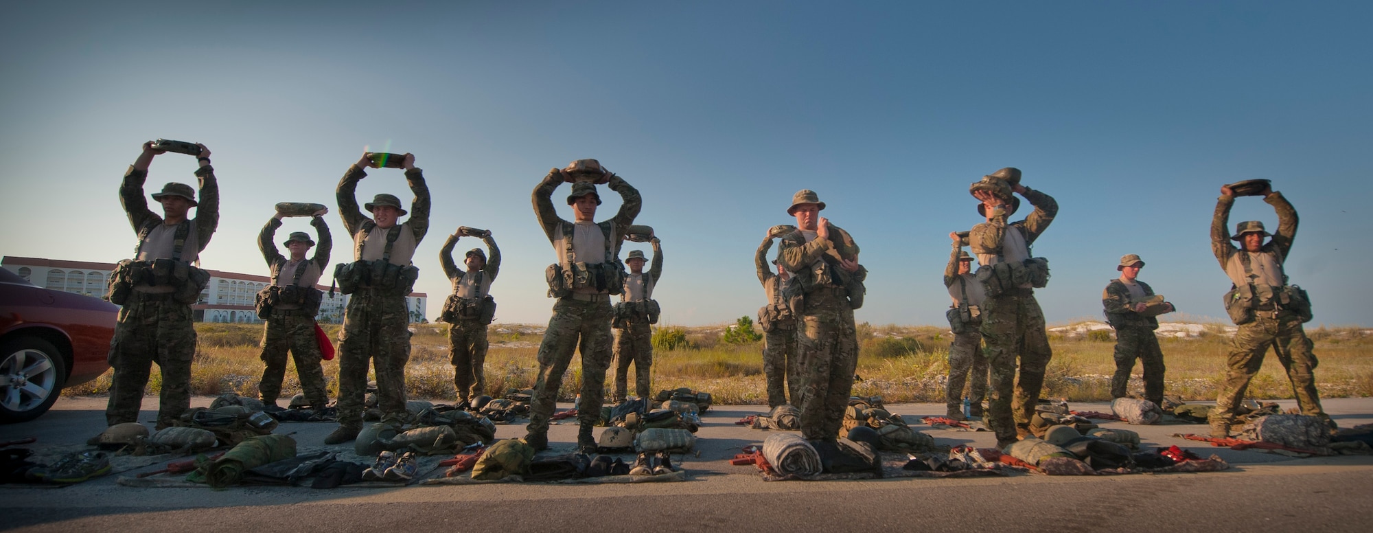 Special Tactics candidates hold up items for inspection after completing a 12-mile ruck march in Fort Walton Beach, Fla., Sept. 13, 2013. The Special Tactics candidates had four hours to complete the ruck march, which is one of the final tests they must pass before graduating technical school. (U.S. Air Force photo/Senior Airman Krystal M. Garrett)