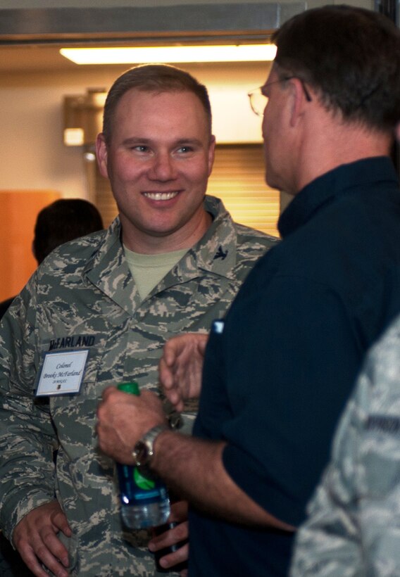Col. Brooks McFarland, 28th Maintenance Group commander, visits with his honorary commander, Rob Mudge, during the civic leader social at the base Deployment Center on Ellsworth Air Force Base, S.D., Sept. 11, 2013. Ellsworth recognized six individuals who completed their terms in the program and introduced five people selected for the 2013 class. (U.S. Air Force photo by Airman 1st Class Alystria Maurer/Released)