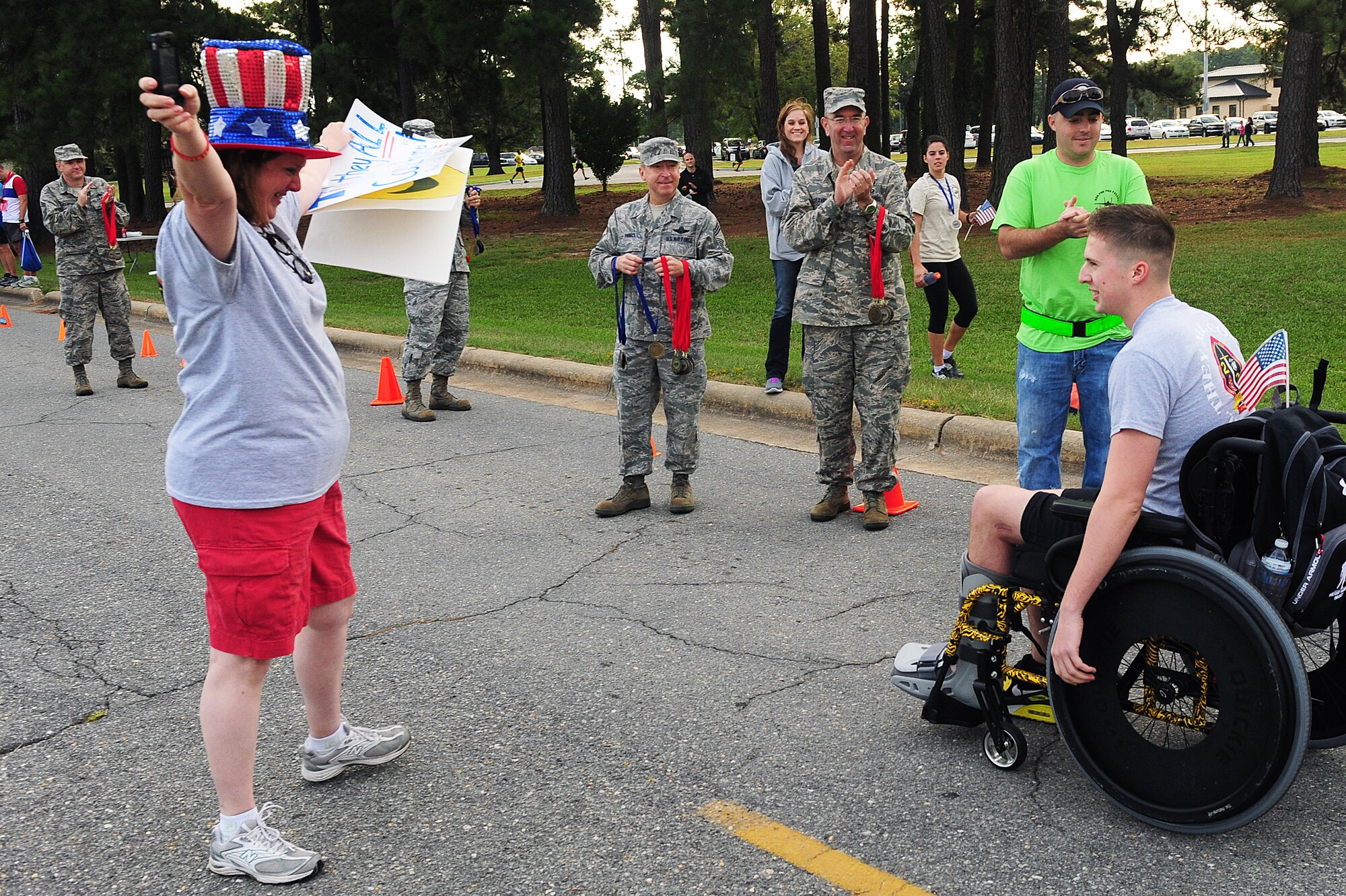 Theresa Mathis greets her son, U.S. Marine Corps Pfc. Duncan Mathis, as he finishes the Run for the Fallen 5K/Half-Marathon hosted by the 4th Fighter Wing Company Grade Officers’ Council, a private organization made up of Air Force lieutenants and captains, at Seymour Johnson Air Force Base, N.C., Sept. 14, 2013.  Mathis was wounded in action during a recent deployment to Afghanistan, falling 75 feet and breaking his legs, ankles and right arm.  After three months of rehab and practicing in his wheelchair for weeks, Mathis accomplished his goal by completing the 5K race.  (U.S. Air Force photo by Airman 1st Class Brittain Crolley)