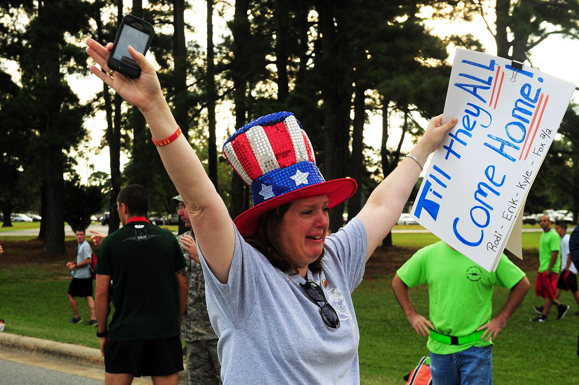 Theresa Mathis cheers for her son, U.S. Marine Corps Pfc. Duncan Mathis, as he finishes his race during the Run for the Fallen 5K/Half-Marathon hosted by the 4th Fighter Wing Company Grade Officers’ Council, a private organization made up of Air Force lieutenants and captains, at Seymour Johnson Air Force Base, N.C., Sept. 14, 2013.  Mathis was severely wounded in action during a recent deployment to Afghanistan and has undergone months of rehab.  “As he crossed, all I could think about was how hard he worked to get to the point he’s at,” Mathis said.  “It was a dream come true.”  (U.S. Air Force photo by Airman 1st Class Brittain Crolley)