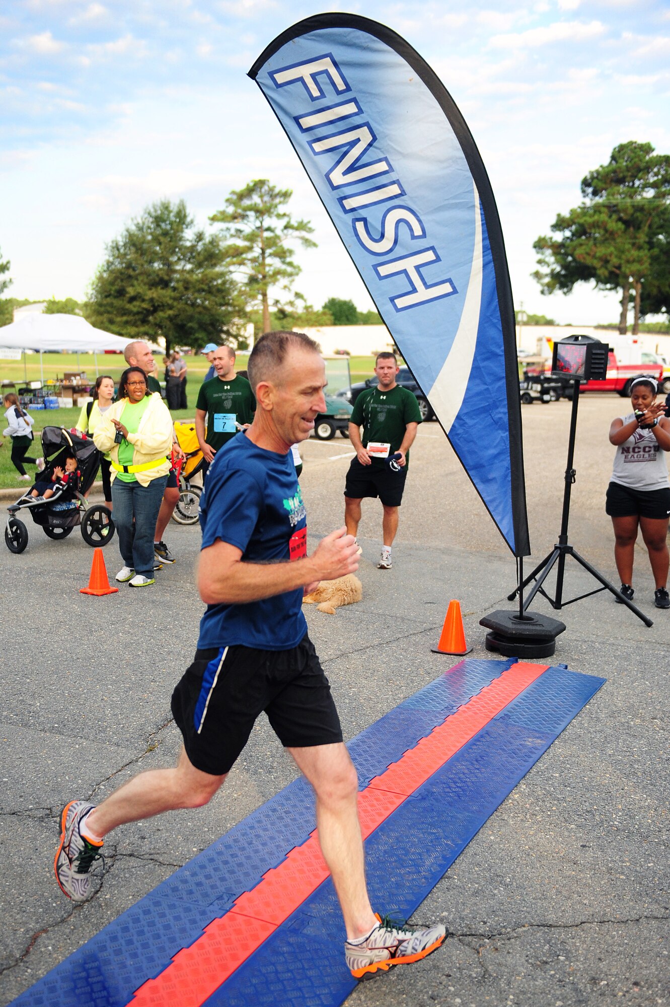 David Nickell, 4th Operations Support Squadron security manager, crosses the finish line during the Run for the Fallen 5K/Half-Marathon hosted by the 4th Fighter Wing Company Grade Officers’ Council, a private organization made up of Air Force lieutenants and captains, at Seymour Johnson Air Force Base, N.C., Sept. 14, 2013.  Nickell finished first in the male, 50-59 age group for the half-marathon, and third overall, with an official time of 1 hour, 30 minutes, 45 seconds.  (U.S. Air Force photo by Airman 1st Class Brittain Crolley)