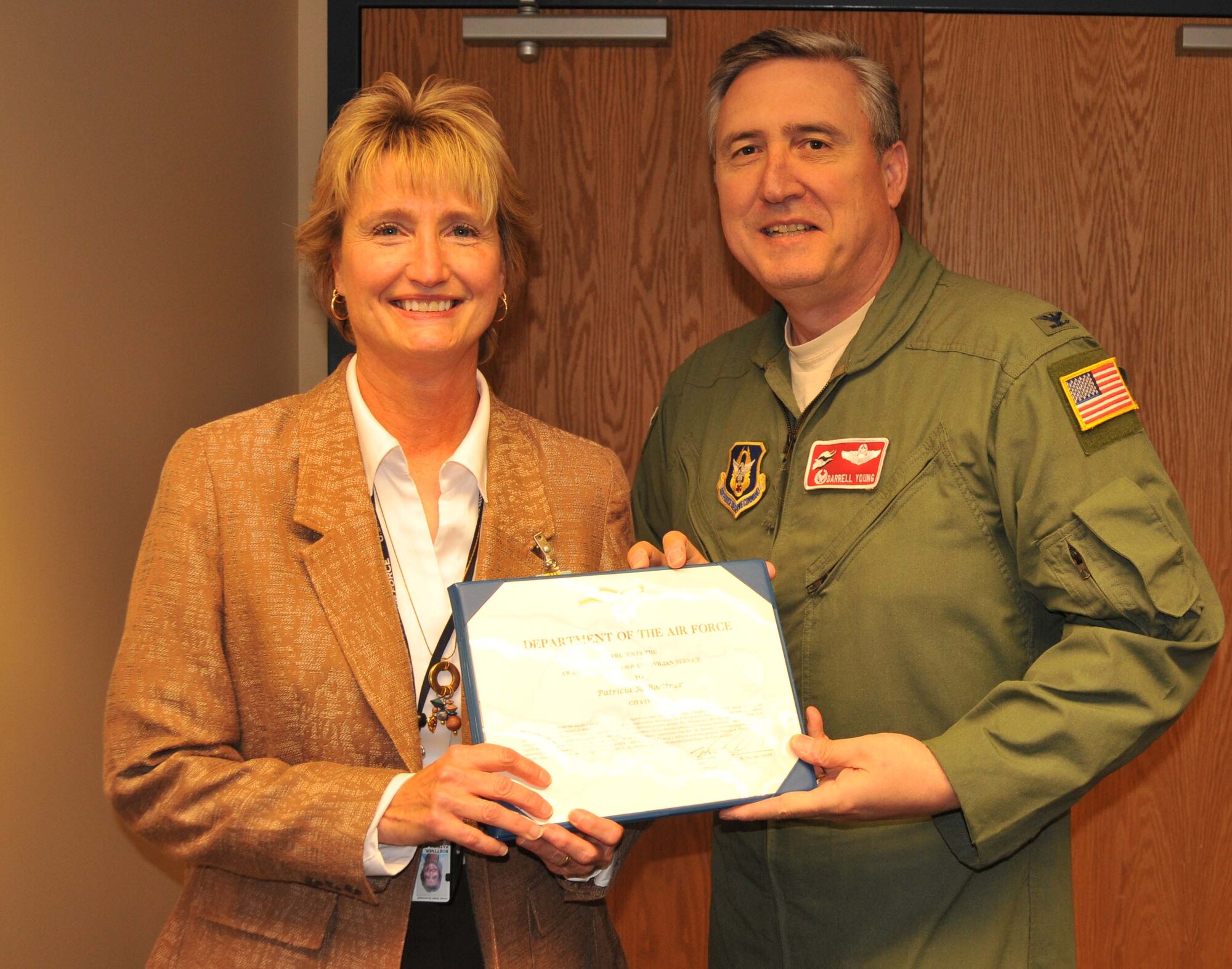 Ms. Patricia A. Boettner, 934th Airlift Wing comptroller, is presented with the Award for Meritorious Civilian Service by Col. Darrell G. Young, 934th Airlift Wing commander Sept. 17.  Ms. Boettner's counsel during extended periods of Continuing Resolution Authority had a significant impact on the wing's ability to ensure that 100 percent of critical wing mission requirements were met. (Air Force Photo/Paul Zadach)