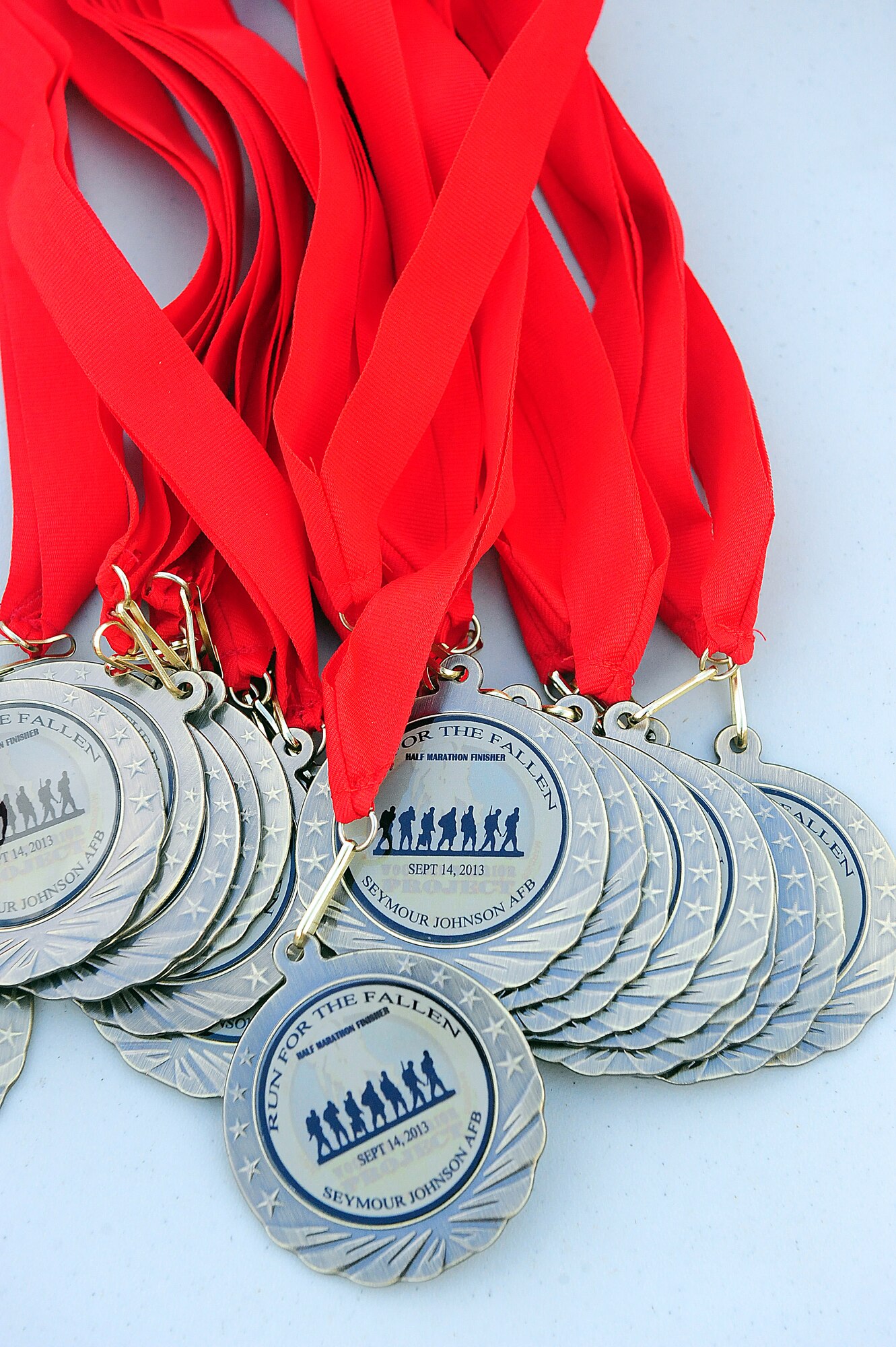 Medals were awarded to each participant who crossed the finish line during the Run for the Fallen 5K/Half-Marathon at Seymour Johnson Air Force Base, N.C., Sept. 14, 2013.  More than 270 participants finished their respective race, hosted by the 4th Fighter Wing Company Grade Officers’ Council, a private organization made up of Air Force lieutenants and captains, which benefitted the Wounded Warrior Project.  (U.S. Air Force photo by Airman 1st Class Brittain Crolley)