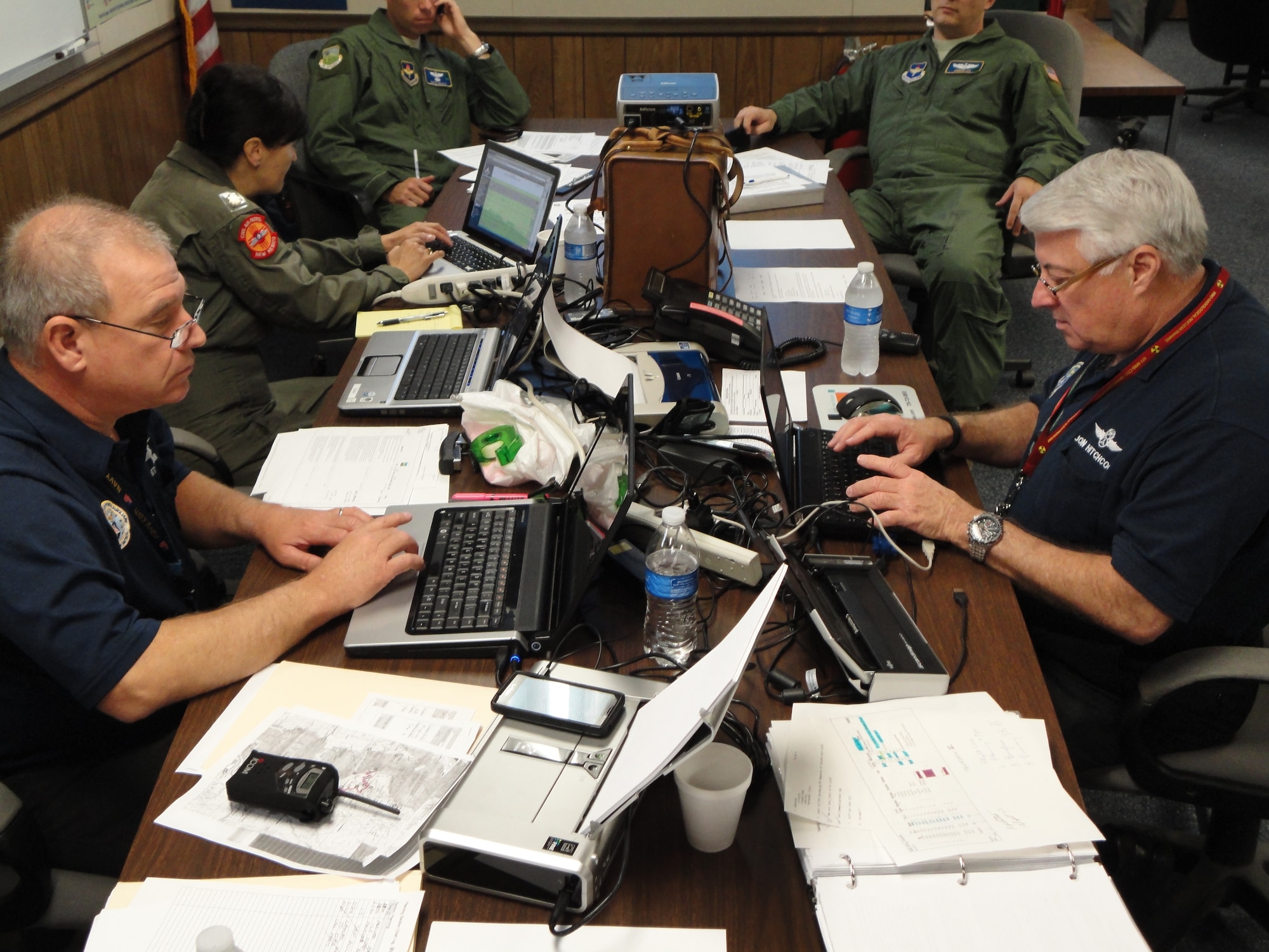 Lt. Col. Jon Hitchcock, right, Civil Air Patrol incident commander, and Maj. Scott Zenonian, Planning Branch Director, stay in touch with members across the state during the CAP New Mexico Wing's evaluation by the U.S. Air Force at Kirtland Air Force Base Sept. 14. (Photo by 2nd Lt Ryan Stark)