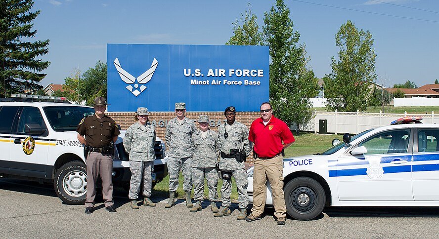 The DUI prevention team at Minot Air Force Base includes members of the 5th Security Forces Squadron law enforcement section, 5th Medical Group Alcohol and Drug Abuse Prevention and Treatment representatives, Staff Judge Advocates, along with local law enforcement officers. The team is part of an initiative to bring agencies together to educate the Minot AFB community on the consequences of driving under the influence. (U.S. Air Force photo/Airman 1st Class Kristoffer Kaubisch)