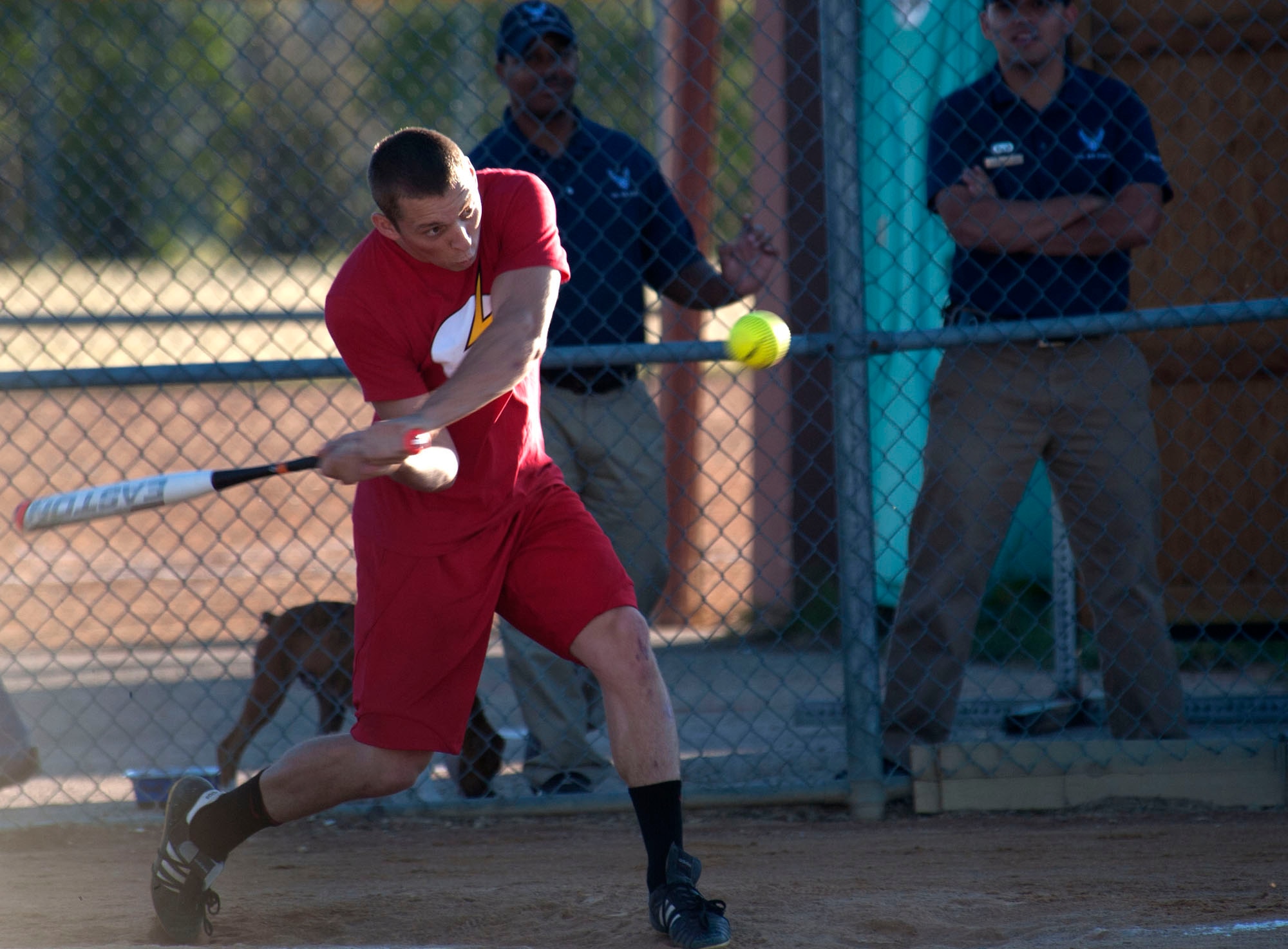 Shortstop Wladimir Sierra, 5th Maintenance Squadron, belts a two run, home run during the second inning of the intramural softball finale against 5th Security Forces Squadron Charlie flight at Minot Air Force Base, N.D., Sept. 12, 2013. The seesaw battle of runs was a back and forth battle with the 5th MXS coming out on top 24-18 in the seven inning affairs. (U.S. Air Force photo/Airman 1st Class Andrew Crawford) 
