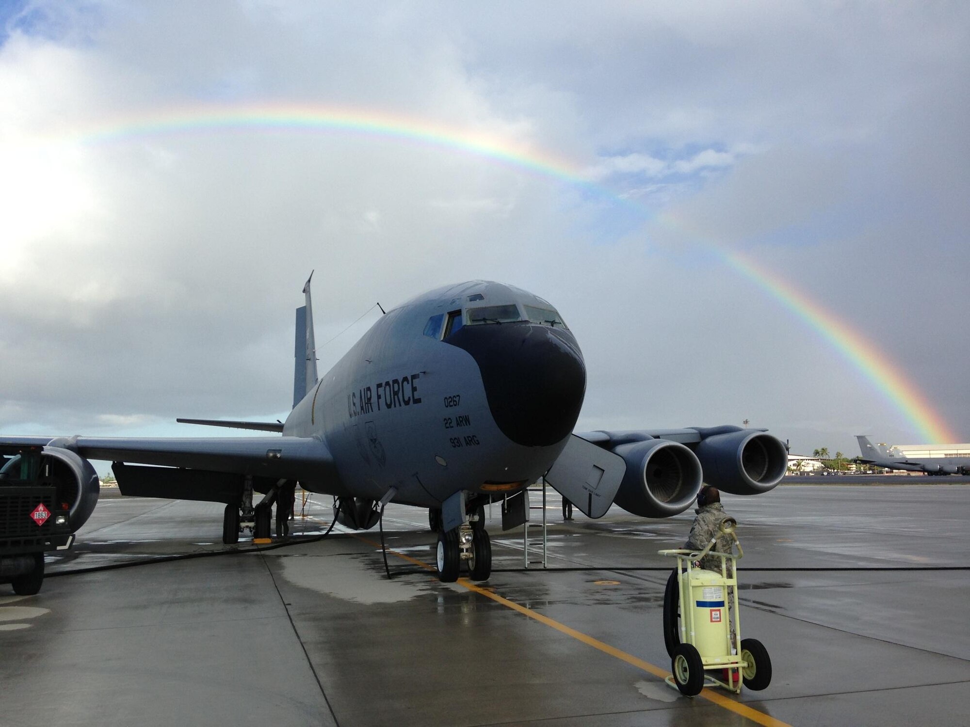 A KC-135 Stratotanker operated by the 18th Air Refueling Squadron gets serviced on the flightline under the arc of a rainbow at Hickam Air Force Base, Hawaii, Sept. 17. Members of the 18th ARS, a subordinate unit of the 931st Air Refueling Group, were in Hawaii conducting aerial refueling. The 931st Air Refueling Group is an Air Force Reserve associate unit to the active duty 22nd Air Refueling Wing based at McConnell Air Force Base, Kan. (Air Force photo by Senior Master Sgt. Presley Lewis)