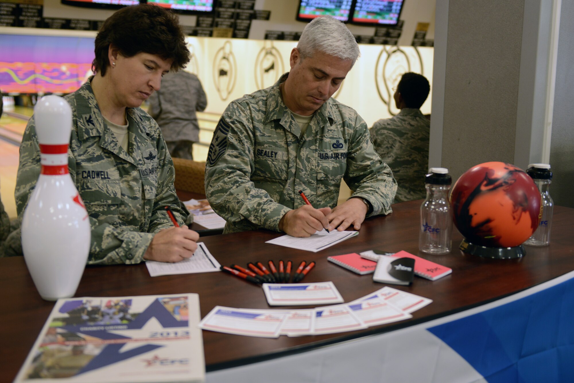 RAF ALCONBURY, United Kingdom - The Combined Federal Campaign kicked off at the 501st Combat Support Wing Sept. 16, 2013, at the RAF Alconbury bowling center with Col. Angela Cadwell, 501st CSW commander, and Chief Master Sgt. Robert Sealey, 501st CSW command chief, making the first donations. The CFC is the world’s largest and most successful annual workplace charity campaign, with almost 200 CFC campaigns throughout the country and overseas raising millions of dollars each year. Please contact your local CFC representative to request a charity list or a pledge form (U.S. Air Force photo by Tech. Sgt. Chrissy Best)