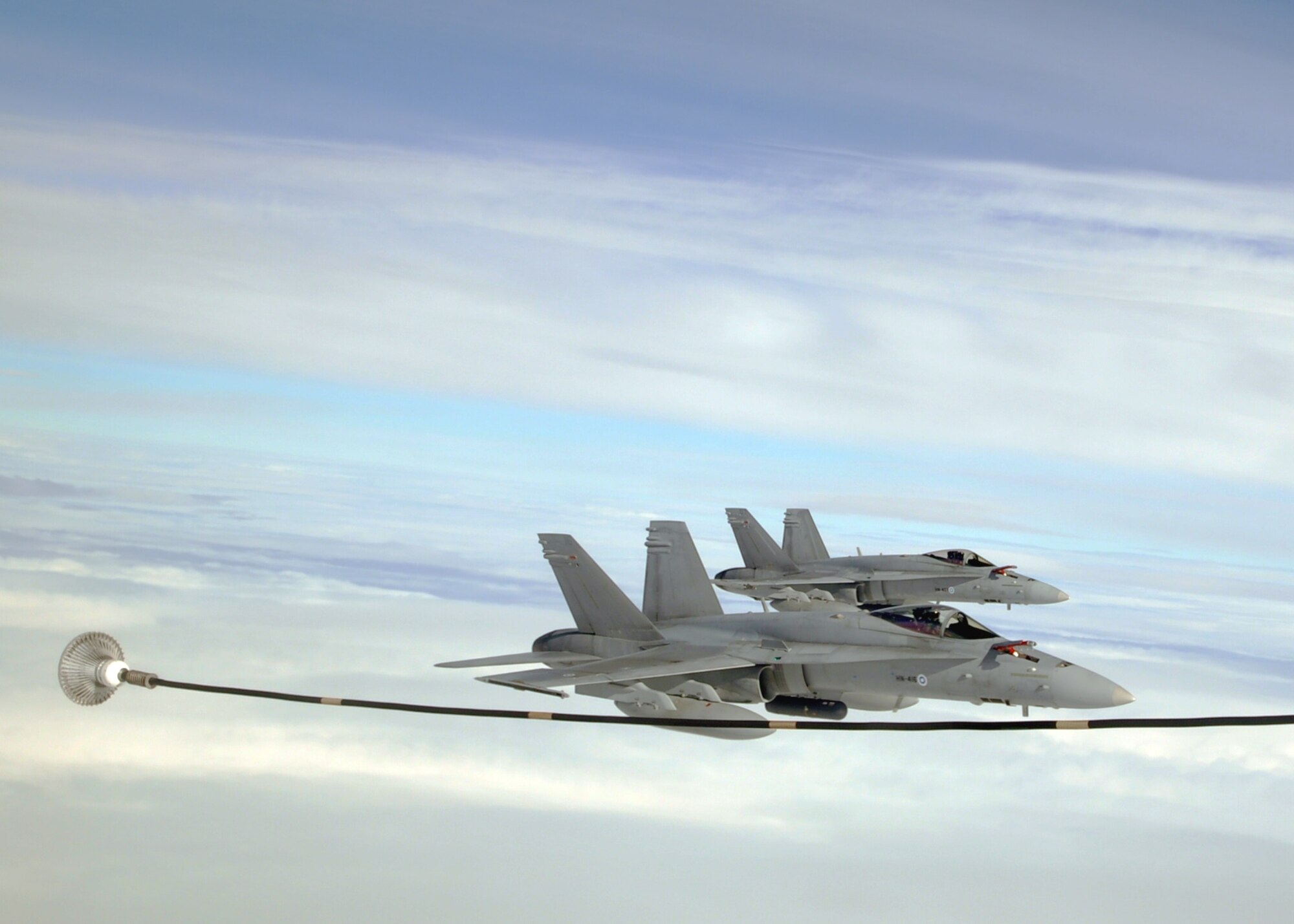 Two Finnish Air Force F-18C Hornets prepare to refuel with a U.S. Air Force KC-135R Stratotanker Sept. 17, 2013, over Norway during the Arctic Challenge exercise. The Hornets formed a “Red Team” strike package with six F-15E Strike Eagles from the 48th Fighter Wing as they attempted to “raid” an enemy command post during this portion of the exercise. (U.S. Air Force photo by 1st Lt. Christopher Mesnard/Released) (Editor’s note: All the maneuvers were performed as simulated exercise scenarios to test and broaden the participants’ knowledge and scope of operations. None are real-world events.)