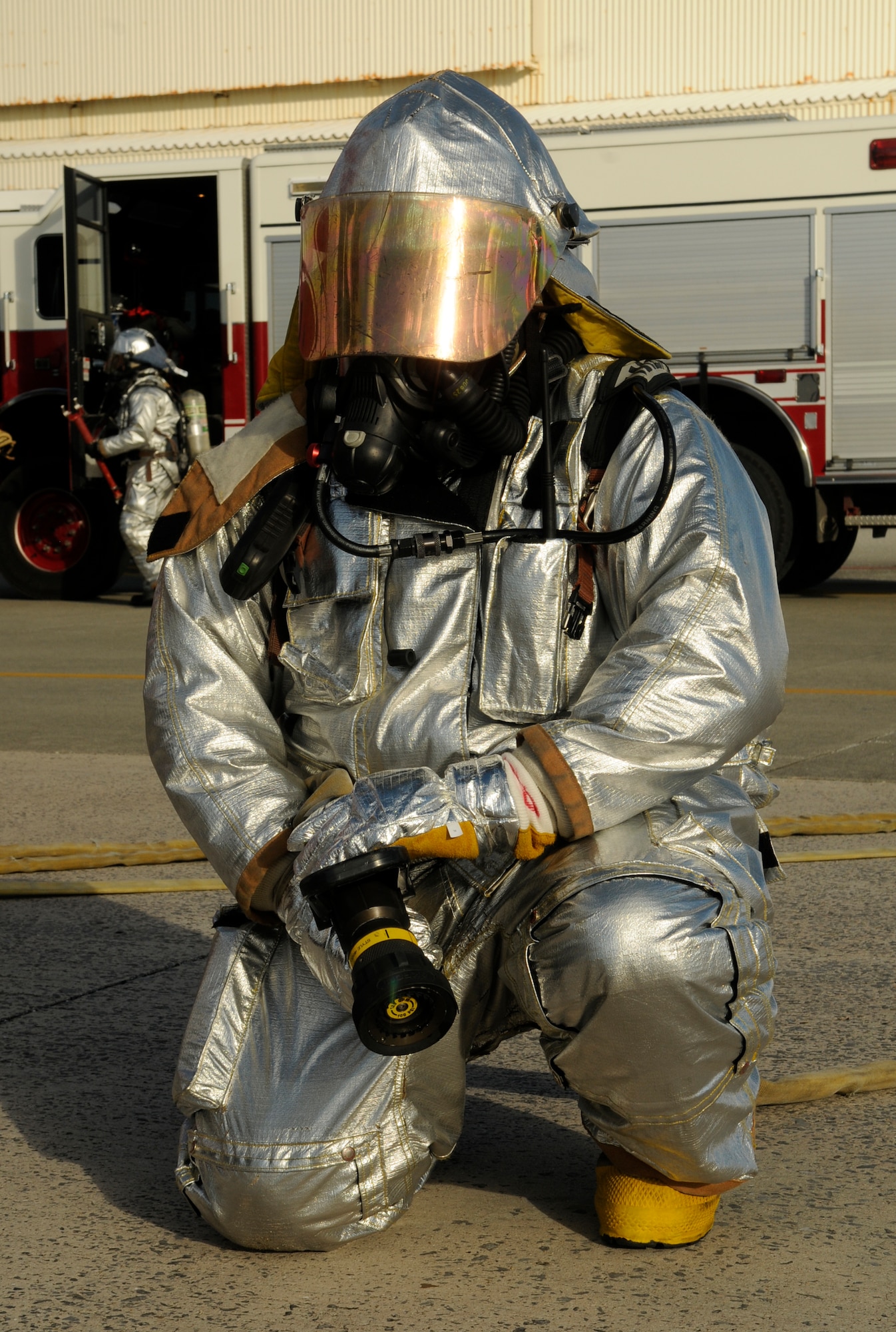 U.S. Air Force Tech. Sgt. Caleb Dacay, 18th Civil Engineer Squadron firefighter, gets into position to put out a simulated fire on an F-15 Eagle during a local operational readiness exercise on Kadena Air Base, Japan, Sept. 12, 2013. The firefighters are timed on how quickly they can extract pilots from an aircraft and put out any fire. (U.S. Air Force photo by Senior Airman Marcus Morris)