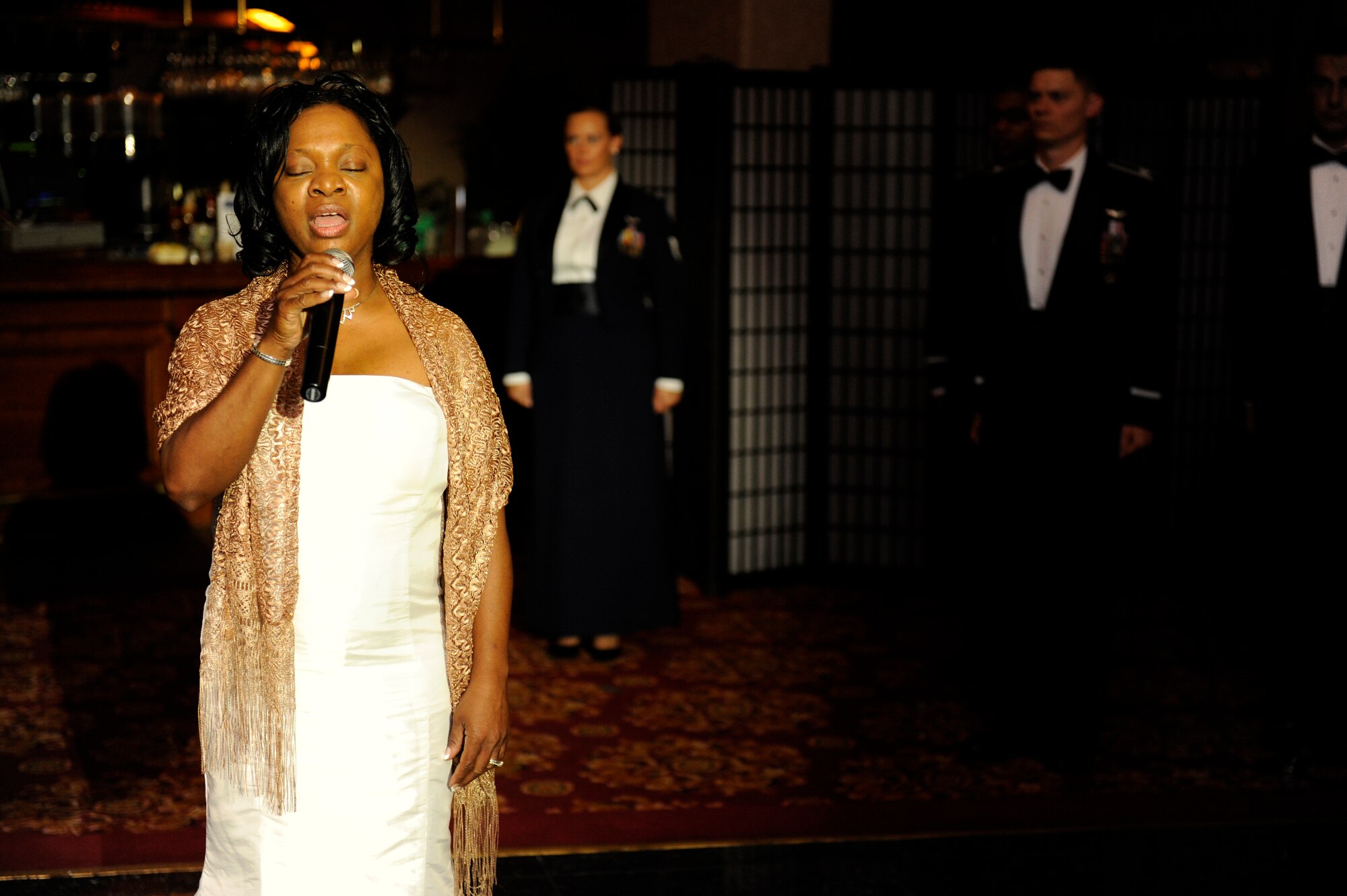 Aretha Neal sings the U.S. national anthem, "The Star Spangled Banner," preceding the 2013 Air Force  Ball on Kadena Air  Base, Japan, Sept. 14, 2013. The 2013 Air Force Ball, which was themed "Shaping Airpower with Innovation," signified the 66th nniversary of the U.S. Air Force. (U.S. Air Force photo by Senior Airman Maeson L. Elleman)
