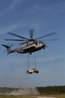 A CH-53 helicopter with Marine Heavy Helicopter Squadron 464 carries a Humvee during a Helicopter Support Team operation as part of Combat Logistics Regiment 25, 2nd Marine Logistics Group’s regimental field exercise aboard Camp Lejeune, N.C., Sept 12, 2013. The exercise gave Marines within the regiment to work together and with supporting units in a simulated deployment environment. (U.S. Marine Corps photo by Lance Cpl. Shawn Valosin)