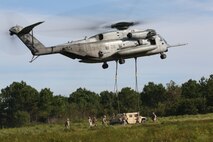 Marines with Combat Logistics Regiment 25, 2nd Marine Logistics Group participate in a Helicopter Support Team operation during a regimental field exercise aboard Camp Lejeune, N.C. Sept 12, 2013. During the exercise, a helicopter with Marine Heavy Helicopter Squadron 464 lifted vehicles and heavy equipment to give the regiment’s service members opportunities to train for air lifts in multiple scenarios. (U.S. Marine Corps photo by Lance Cpl. Shawn Valosin)