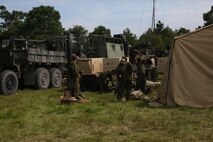 Marines and sailors put on protective clothing during a simulated chemical threat aboard Camp Lejeune, N.C. Sept. 11, 2013. This was just one of many drills performed during a field exercise by Combat Logistics Regiment 25. (U.S. Marine Corps photo by Lance Cpl. Shawn Valosin)