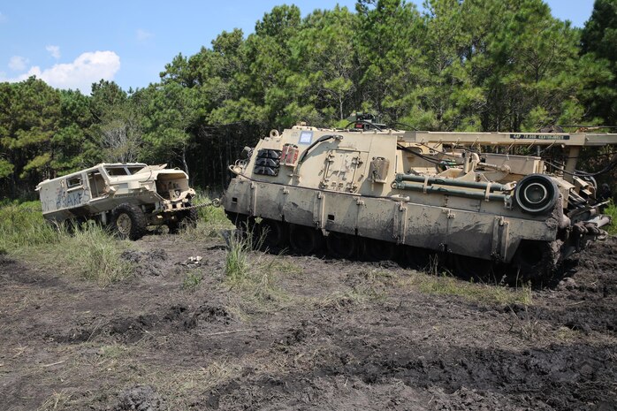 Marines with Ordnance Maintenance Company, 2nd Maintenance Battalion, 2nd Marine Logistics Group practice vehicle recovery operations during a field exercise aboard Camp Lejeune, N.C. Sept 9, 2013. The company completed the operation as a part of its annual training requirements and allowed junior Marines to learn from their seniors in a simulated deployed environment.  (U.S. Marine Corps photo by Lance Cpl. Shawn Valosin)