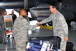 Lt. Gen. Stanley E. Clarke III meets Staff Sgt. Brandon Johnson of the 182nd Civil Engineer Squadron to receive a briefing on urban search and rescue equipment during a visit at the 182nd Airlift Wing in Peoria, Ill., Sep. 6, 2013.