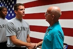 U.S. Army Master Sgt. Richard Hitchens gives words of encouragement to Pvt. Spencer Bradford, a new recruit with the DNG who attended Hitchens' retirement ceremony held at Bethany Beach Training Site, Bethany Beach, Del., Sept. 7.