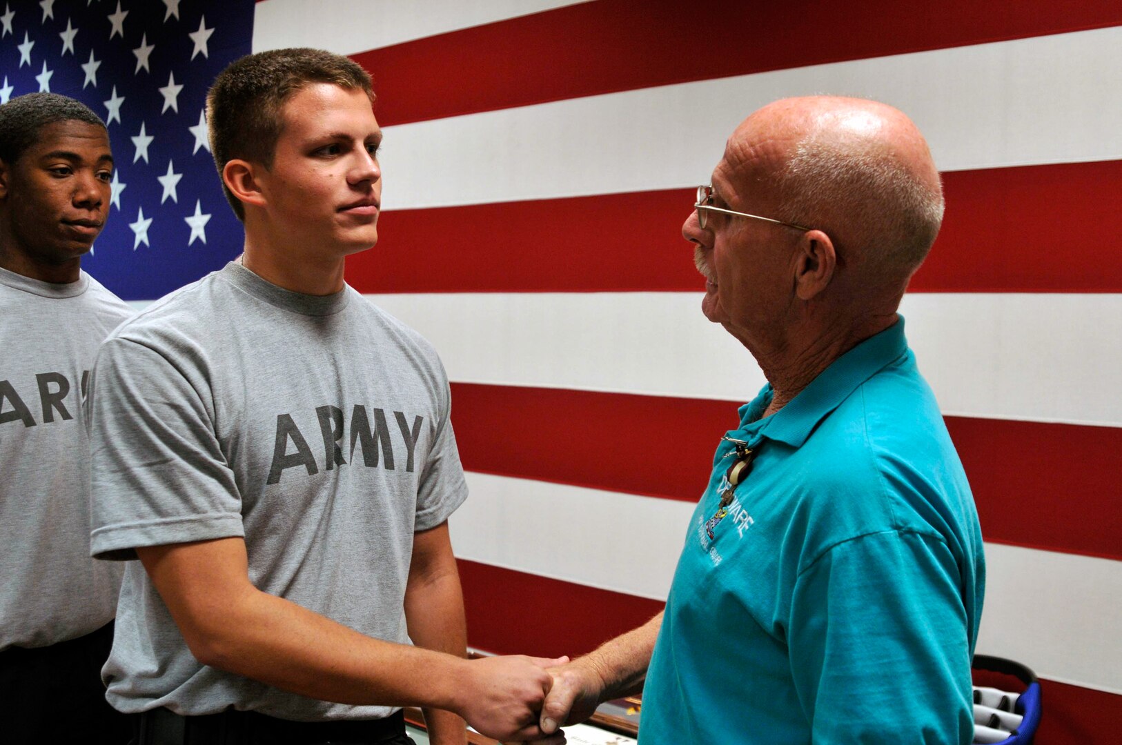 U.S. Army Master Sgt. Richard Hitchens gives words of encouragement to Pvt. Spencer Bradford, a new recruit with the DNG who attended Hitchens' retirement ceremony held at Bethany Beach Training Site, Bethany Beach, Del., Sept. 7.