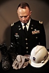 Army National Guard Chief Warrant Officer 4 Clifford Bauman, while at Langley Air Force Base, Va., Aug. 22, 2013, reflects on the boots, gloves and hat he wore during search and rescue missions at the Pentagon after the Sept. 11, 2001 attacks.