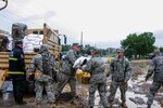 Soldiers and Airmen from the Colorado National Guard, along with members of civilian emergency response agencies, distribute sandbags to overly saturated areas of Jefferson County, Colo., Sept. 15, 2013. Rescue units have evacuated thousands of people and animals in areas of Colorado that have been devastated by the record-setting flood.