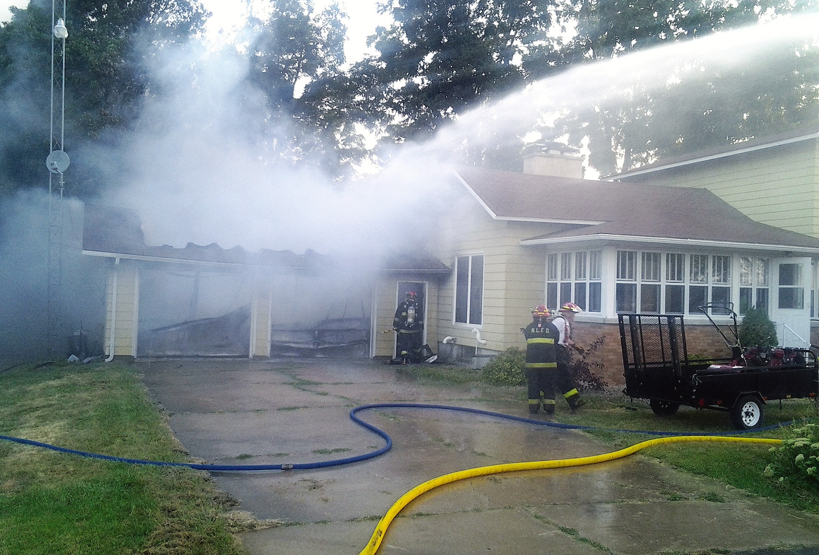 New Lisbon Fire Department personnel at a garage fire just outside of New Lisbon, Wis., on Aug. 30. Wisconsin Air National Guard Capt. John McKenna was first on the scene, called 911 and alerted the sleeping family.