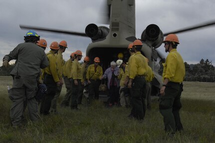 Members of Bravo Company, 2nd Battalion, 135th General Support Aviation Battalion, Colorado National Guard and rescue personnel escort residents of an affected flood area, Sept. 18, 2013, near Fort Collins, Colo. What is being dubbed “Operation Centennial Raging Waters” is likely the biggest rotary-wing airlift mission since Hurricane Katrina. (U.S. Air Force Photo by Senior Airman Kendra Alba/Released