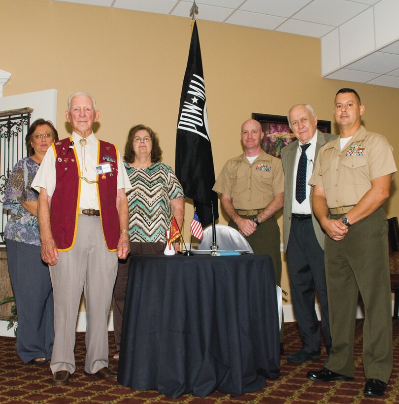 Guest speaker Maj. Alexander J. Vanston, right, commanding officer, Headquarters Company East, Marine Corps Logistics Command, stands with former Prisoners of War and family members of former POWs Friday during Marine Corps Logistics Base AlbanyÕs annual Prisoners of War/Missing in Action Recognition Breakfast, here.