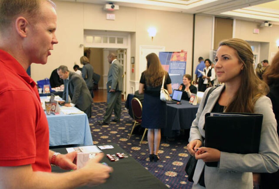 Katherine Herdener, military spouse aboard Marine Corps Base Quantico, talks with Charlie Miles, director of military programs at ManTech, during the U.S. Chamber of Commerce Foundation and Hiring Our Heroes’ Military Spouse Employment Program job fair Sept. 5, at the Clubs at Quantico.